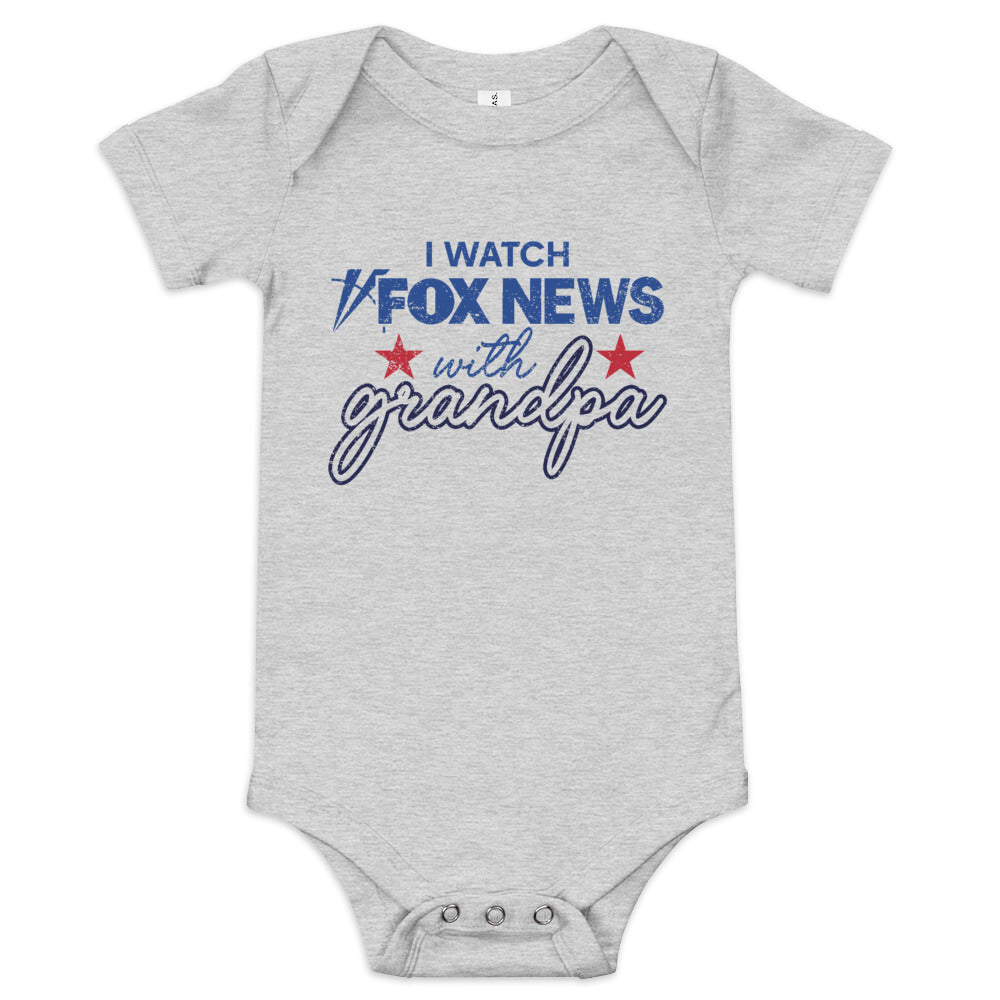 A soft white baby bodysuit featuring the text I Watch with Grandpa and the iconic FOX News logo in a clean American home setting.