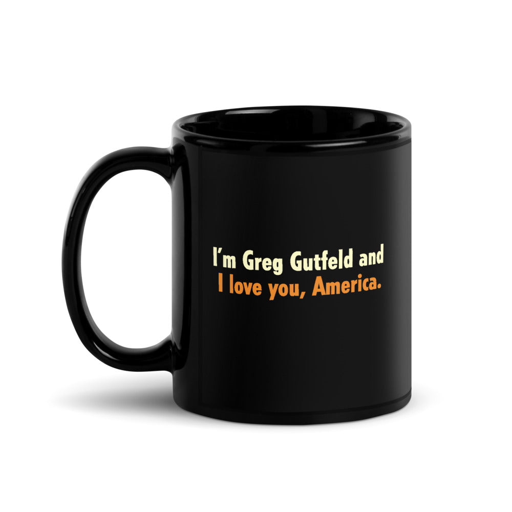 A black glossy Gutfeld! ceramic mug featuring white text that reads I'm Greg Gutfeld and I love you, America in a clean American kitchen setting.