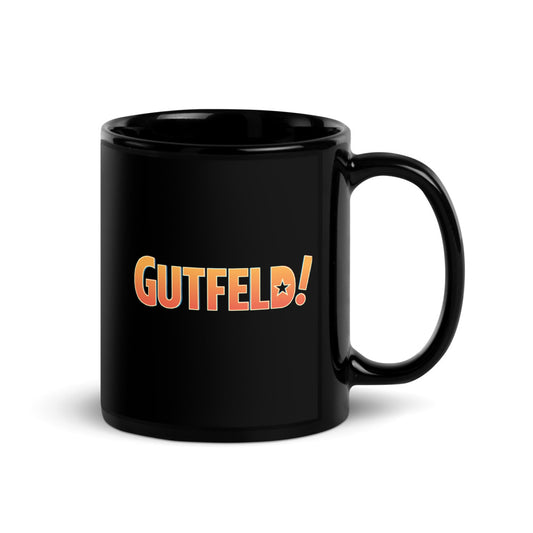 Side view of the official Fox News Gutfeld! coffee cup showcasing the glossy finish and sturdy handle on a modern wooden desk.