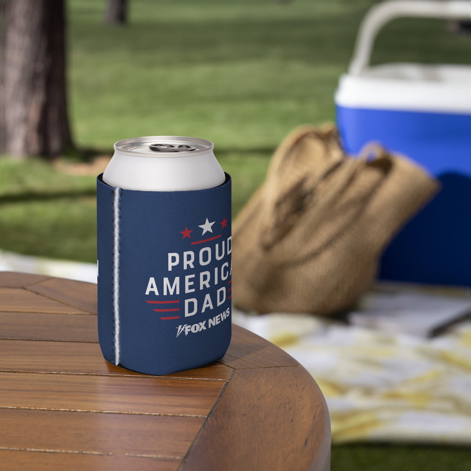 An outdoor lifestyle shot showing a patriotic American dad relaxing on a deck with the FOX News insulated can cooler in hand.