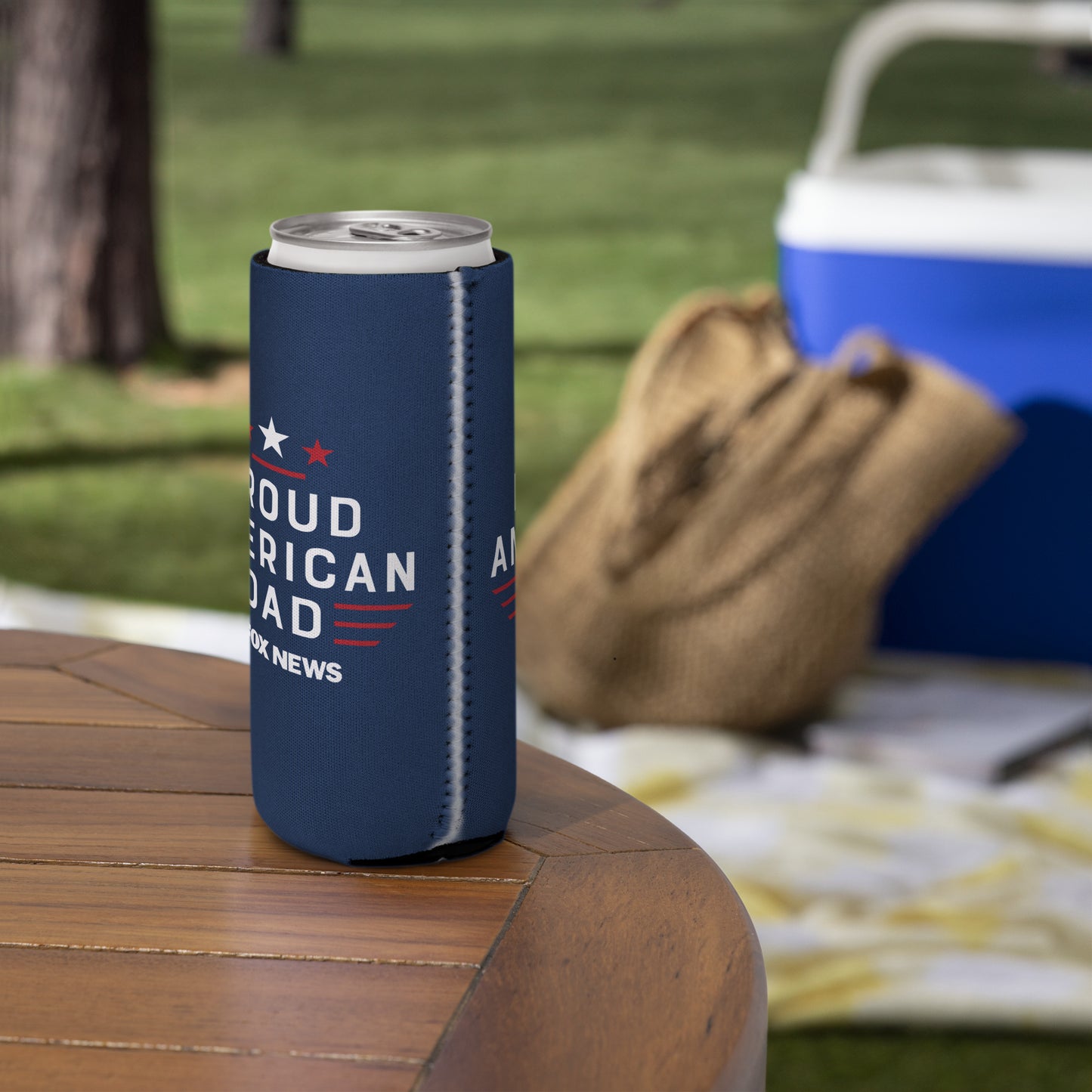 A clean product studio flat lay of the FOX News Proud American Dad can cooler against a neutral American-themed background.
