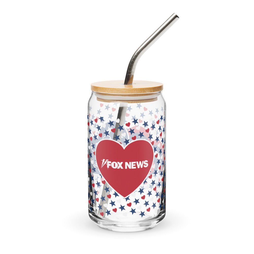 A 16 oz can-shaped glass featuring the FOX News Proud American hearts and stars design on a clean wooden table in a suburban American kitchen.