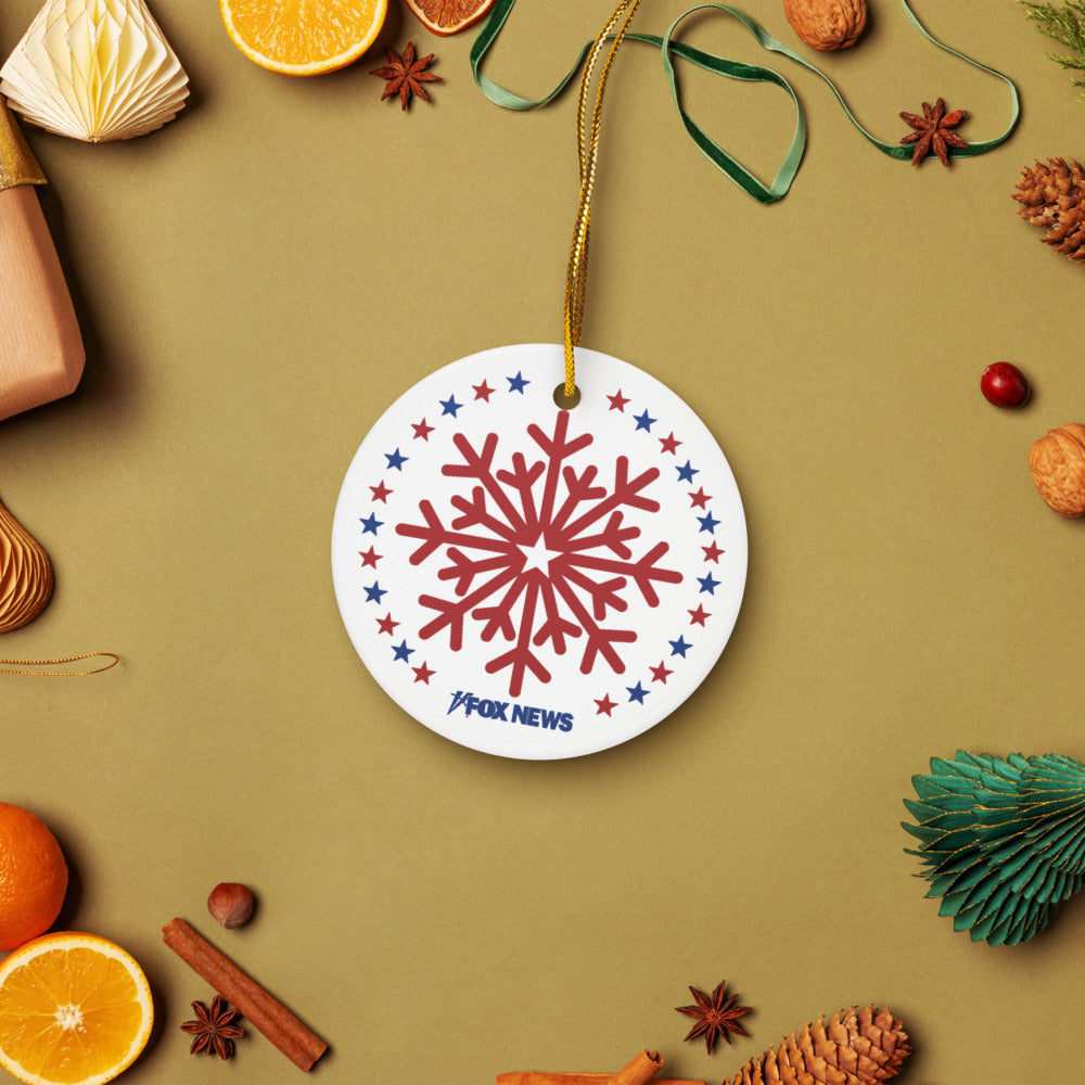 A stack of FOX News ceramic ornaments showing both circle and snowflake shapes in a festive gifting context.