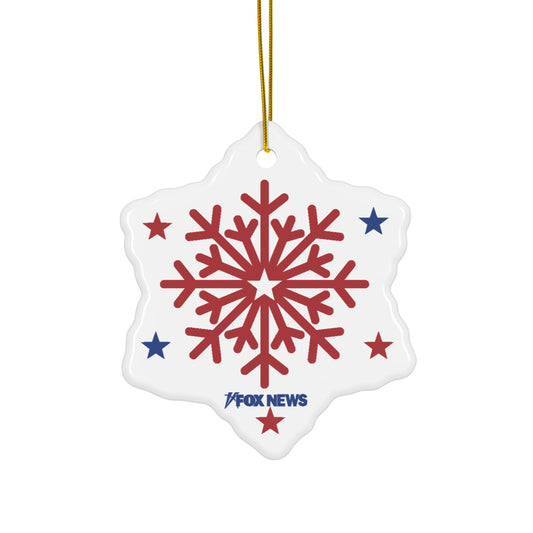 A snowflake-shaped ceramic ornament with the FOX News logo displayed against a festive, suburban holiday background.
