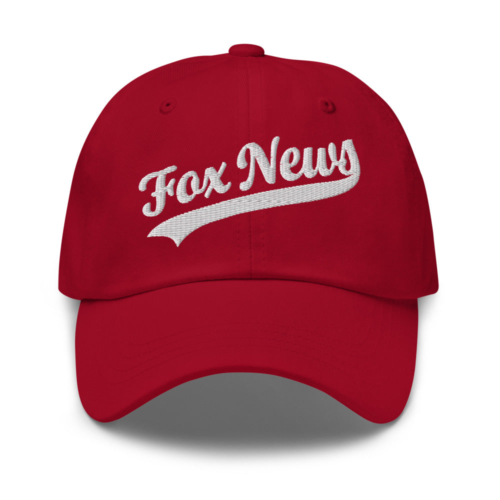 An adult fan wearing the FOX News dad hat outdoors on a clear autumn morning.