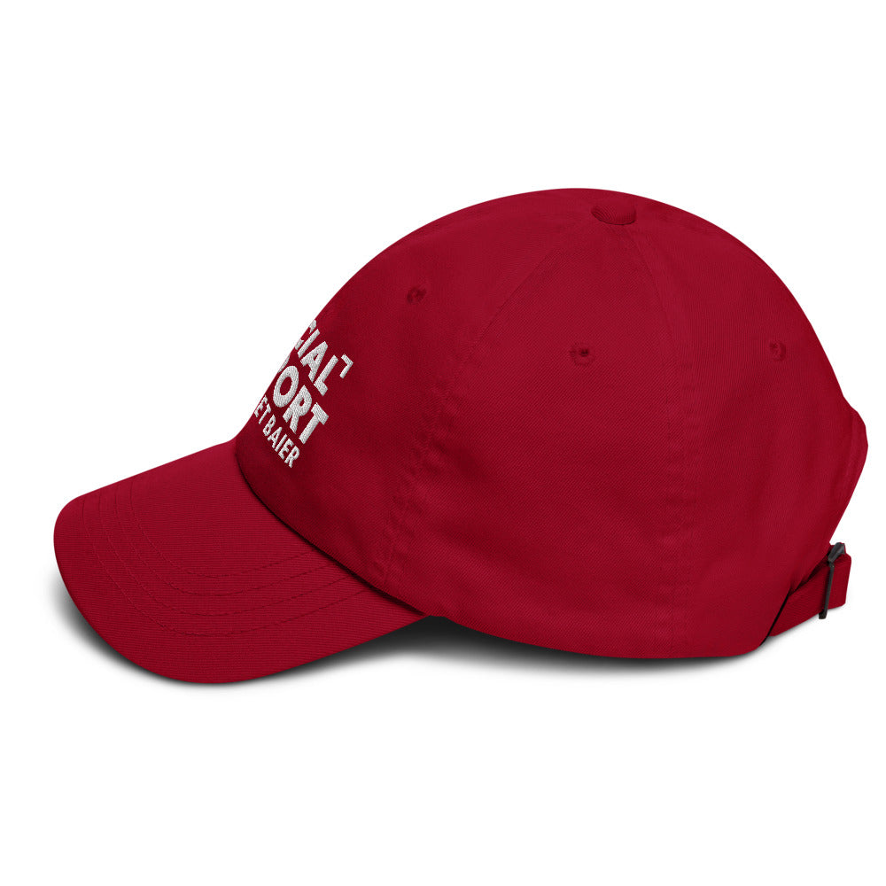 An outdoor backyard morning coffee setting with the FOX News Special Report with Bret Baier hat displayed in natural sunlight.