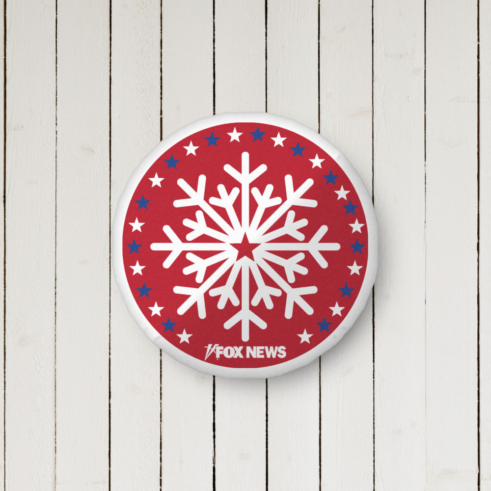 The 16x16 FOX News Holiday Snowflakes Pillow displayed on a sofa, showing the crisp logo and festive graphic design.