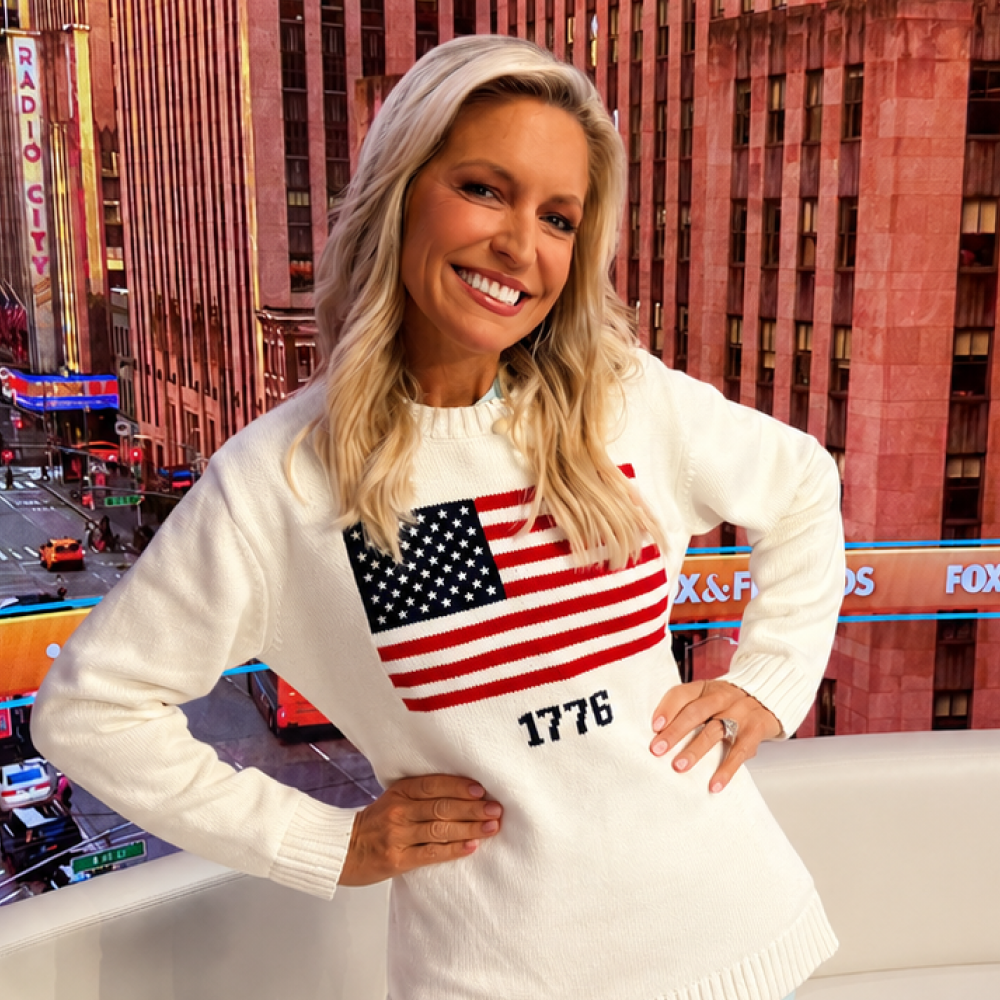 A modern American living room featuring the FOX News 1776 American Flag Knit Sweater neatly displayed on a rustic wooden table.