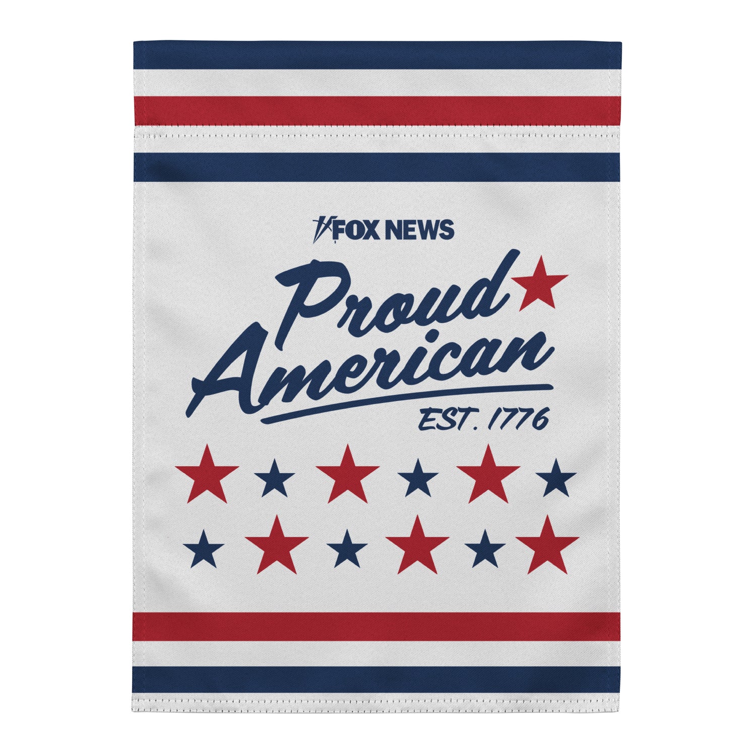 Official FOX News Proud American Est. 1776 Garden Flag displayed on a black metal stand in a well-manicured American suburban garden.