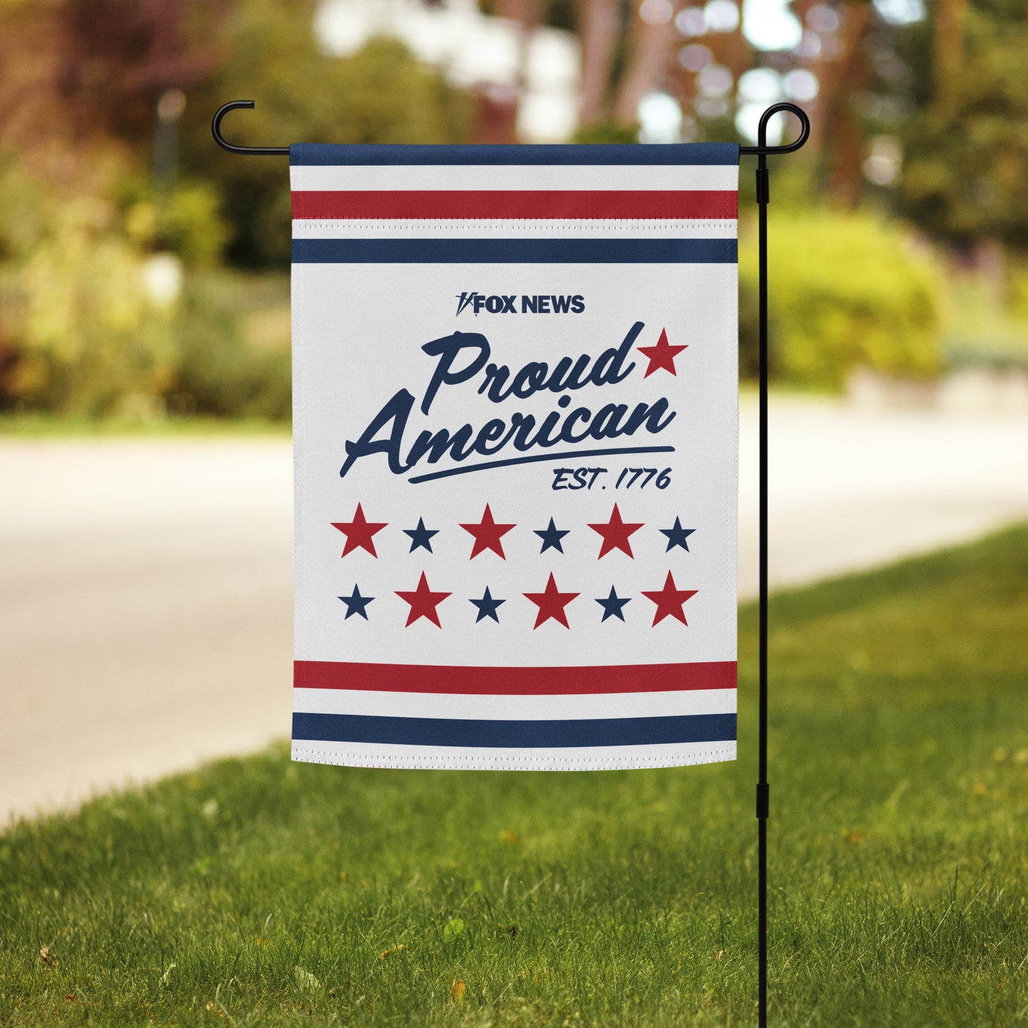 Close-up of the FOX News logo and Proud American Est. 1776 graphic on the high-quality fabric of the garden flag.