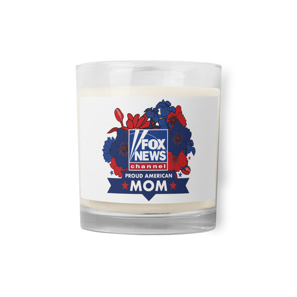 An officially licensed FOX News Proud American Mom Glass Soy Wax Candle sitting on a clean white end table in a bright modern American living room.