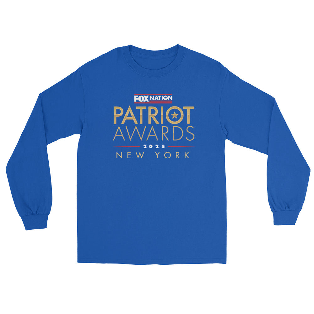 A man standing in a suburban backyard wearing the royal blue version of the *FOX Nation* long sleeve shirt.