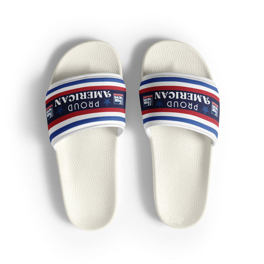A pair of *FOX News* *Proud American* Men's Slides resting on a clean suburban patio, highlighting the bold red, white, and blue logo design.