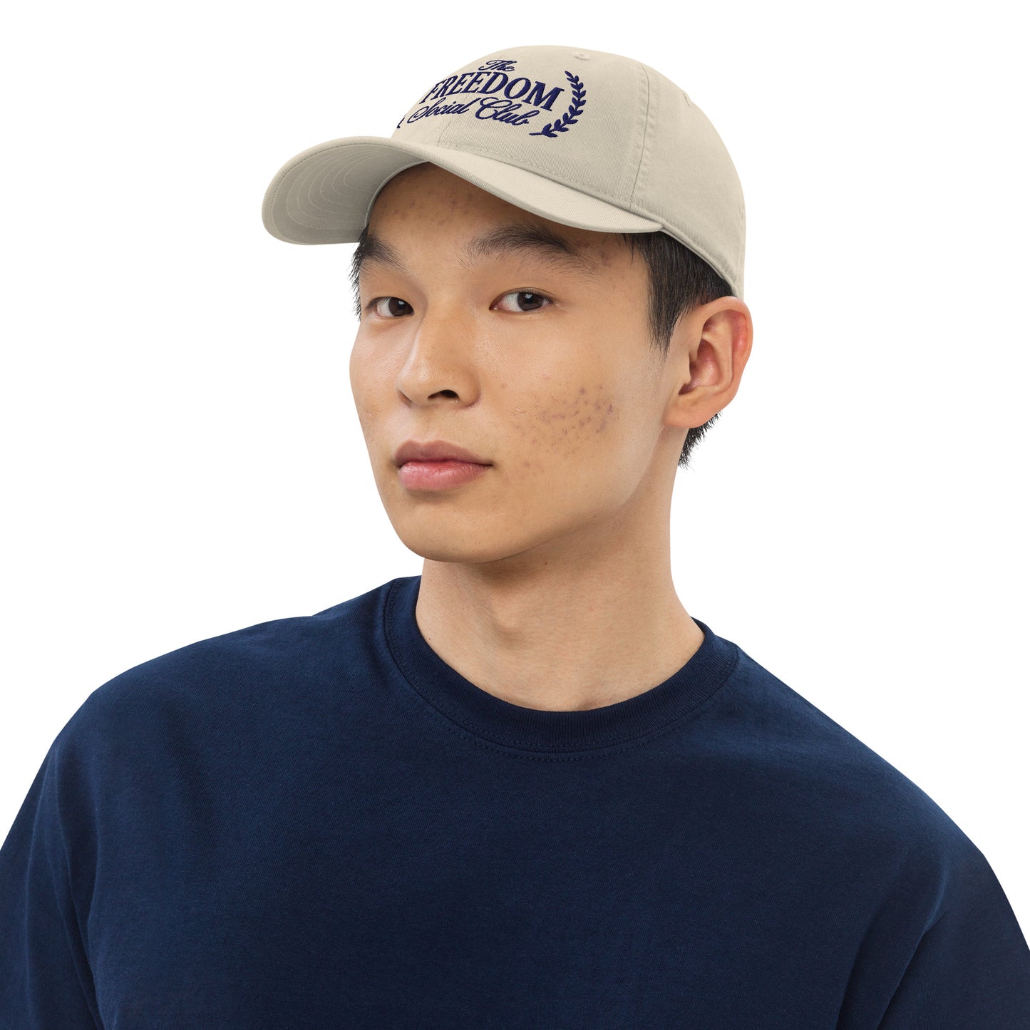 Side profile view of the organic cotton baseball cap resting in a bright, modern American living room