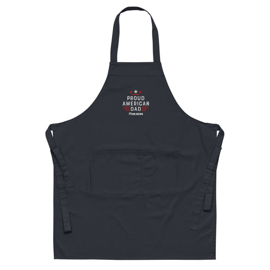 A proud American dad wearing the FOX News Proud American Dad Embroidered Apron in a modern suburban kitchen
