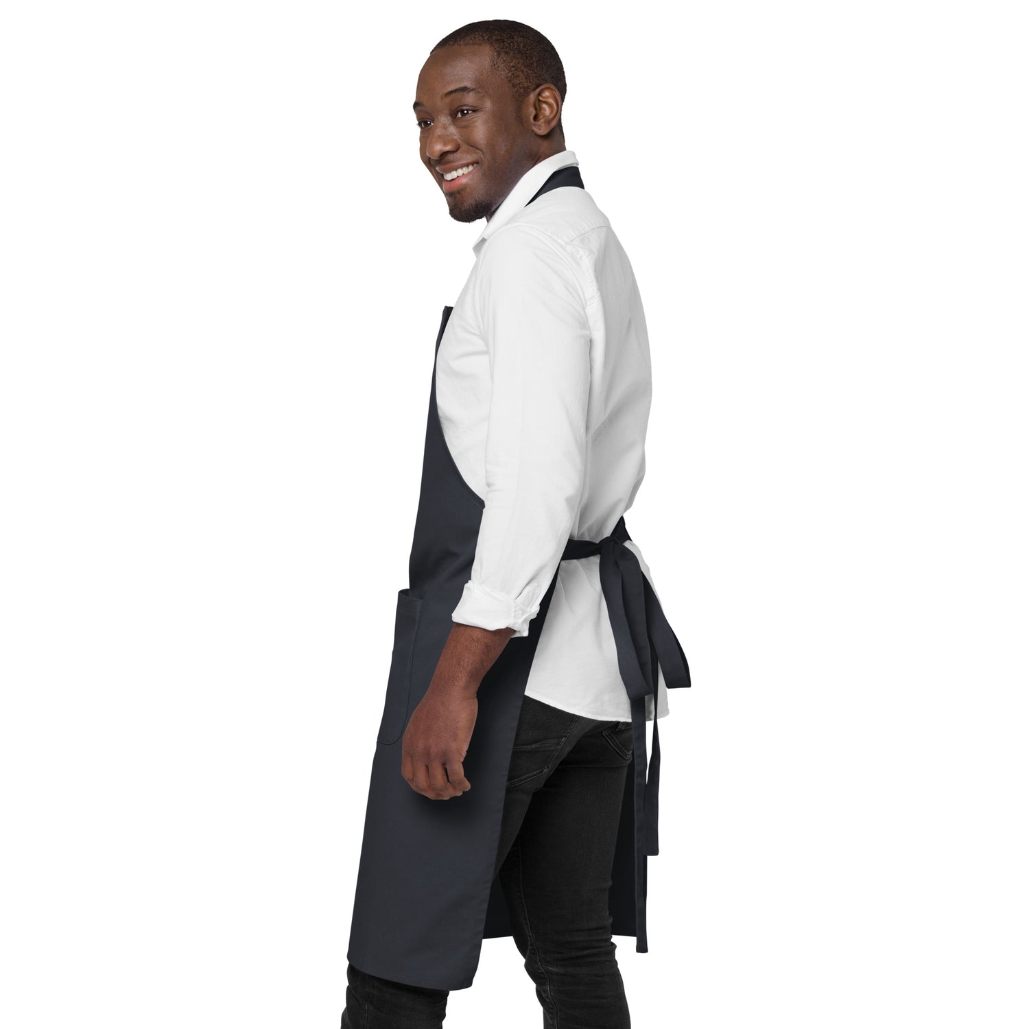The FOX News Proud American Dad Embroidered Apron folded neatly on a wooden kitchen island