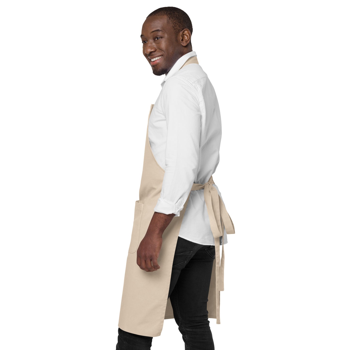 A dad preparing a family meal in the kitchen while wearing the FOX News Proud American apron