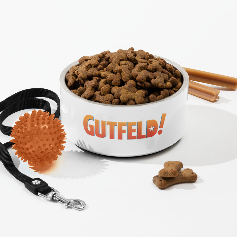 Lifestyle product shot of the *Gutfeld!* pet bowl in a comfortable home setup.