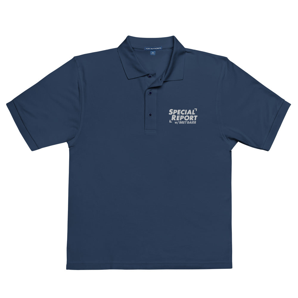 A man wearing the Navy *Special Report with Bret Baier* embroidered polo shirt in a well-lit American home office.