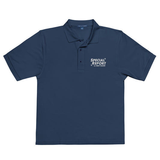 A man wearing the Navy *Special Report with Bret Baier* embroidered polo shirt in a well-lit American home office.