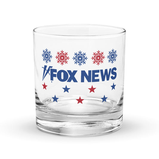 A FOX News Holiday Snowflakes Rocks Glass sitting on a clean wooden table in a festive American home setting.-0