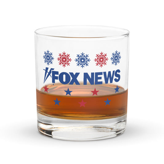 A FOX News Holiday Snowflakes Rocks Glass sitting on a clean wooden table in a festive American home setting.-1