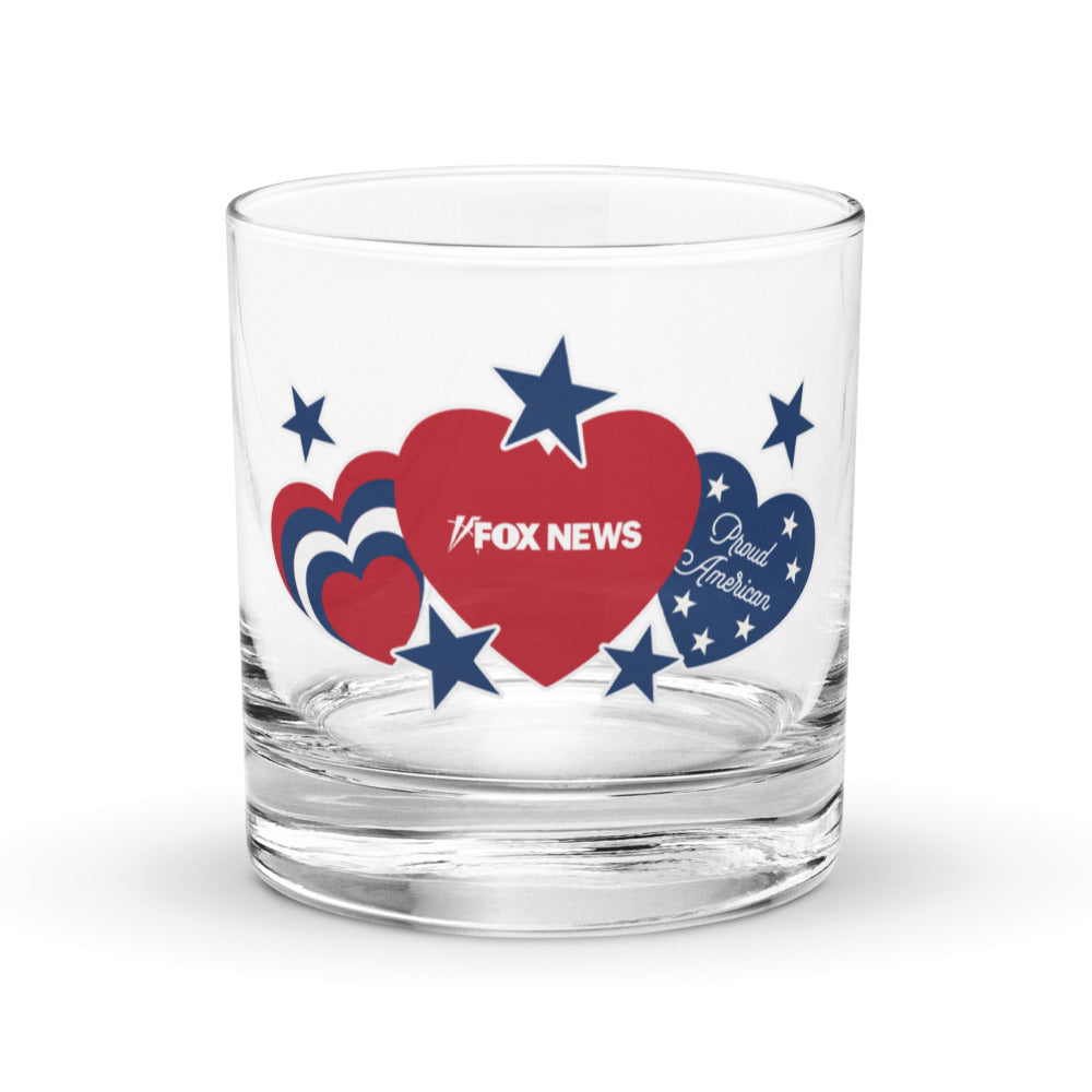 A crisp FOX News Proud American Hearts And Stars Rocks Glass sitting on a wooden table in a sunlit American home.