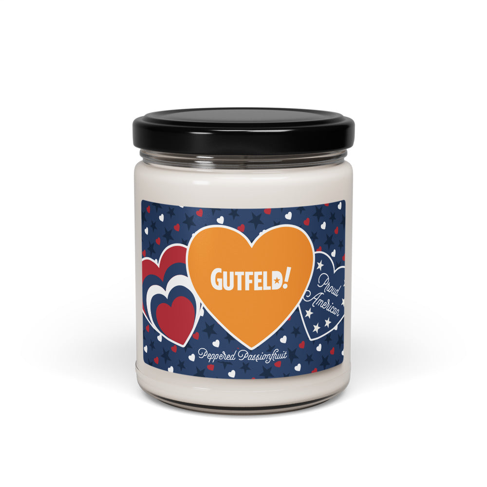 A Gutfeld! Proud American Hearts And Stars Candle sitting on a wooden side table in a clean, modern American living room.