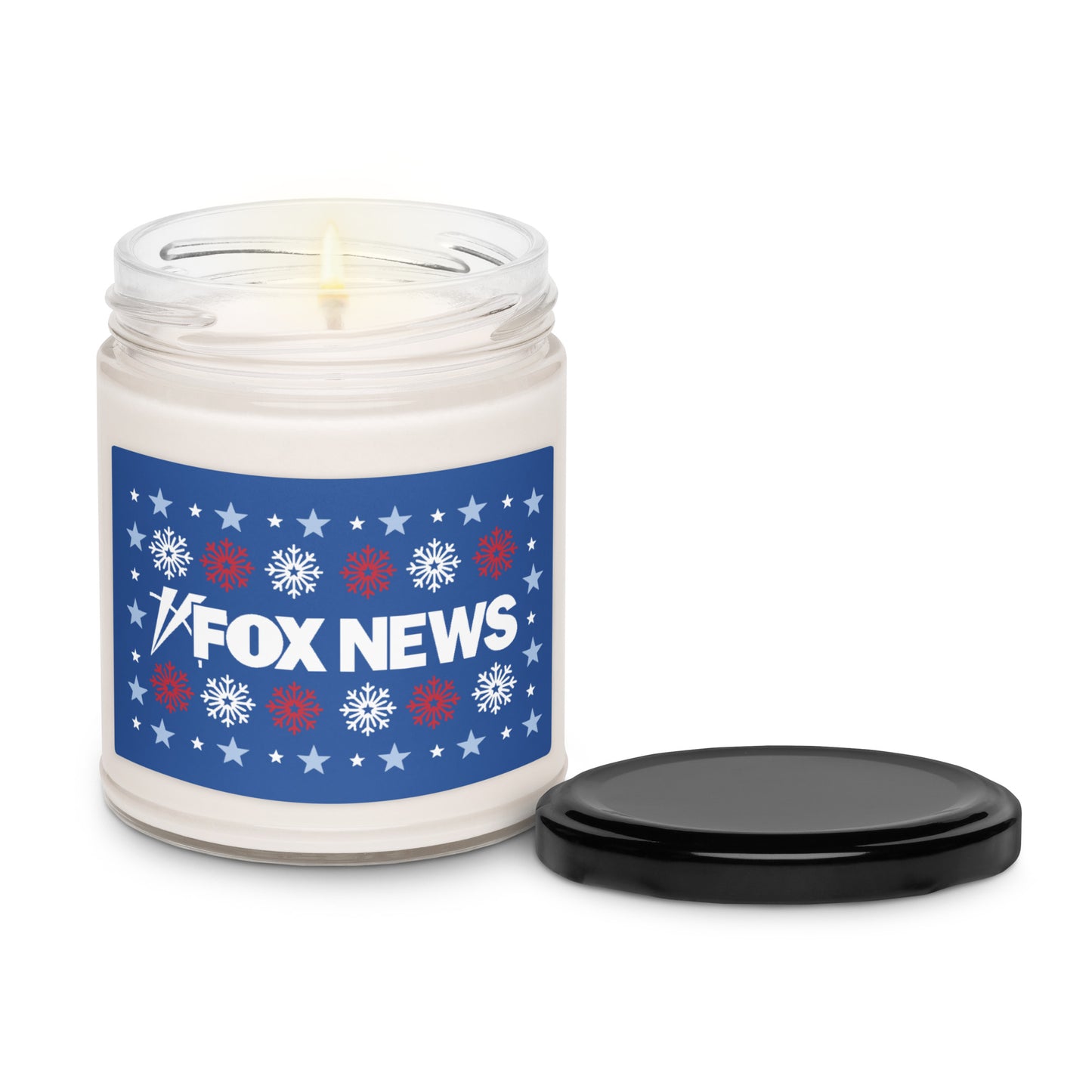 An inviting tabletop display featuring the FOX News holiday candle alongside evergreen sprigs in a suburban American home.