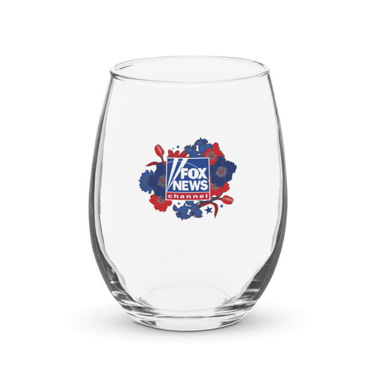 Close-up shot of the FOX News Proud American Mom stemless wine glass resting on a clean wooden tabletop in a bright suburban home setting.