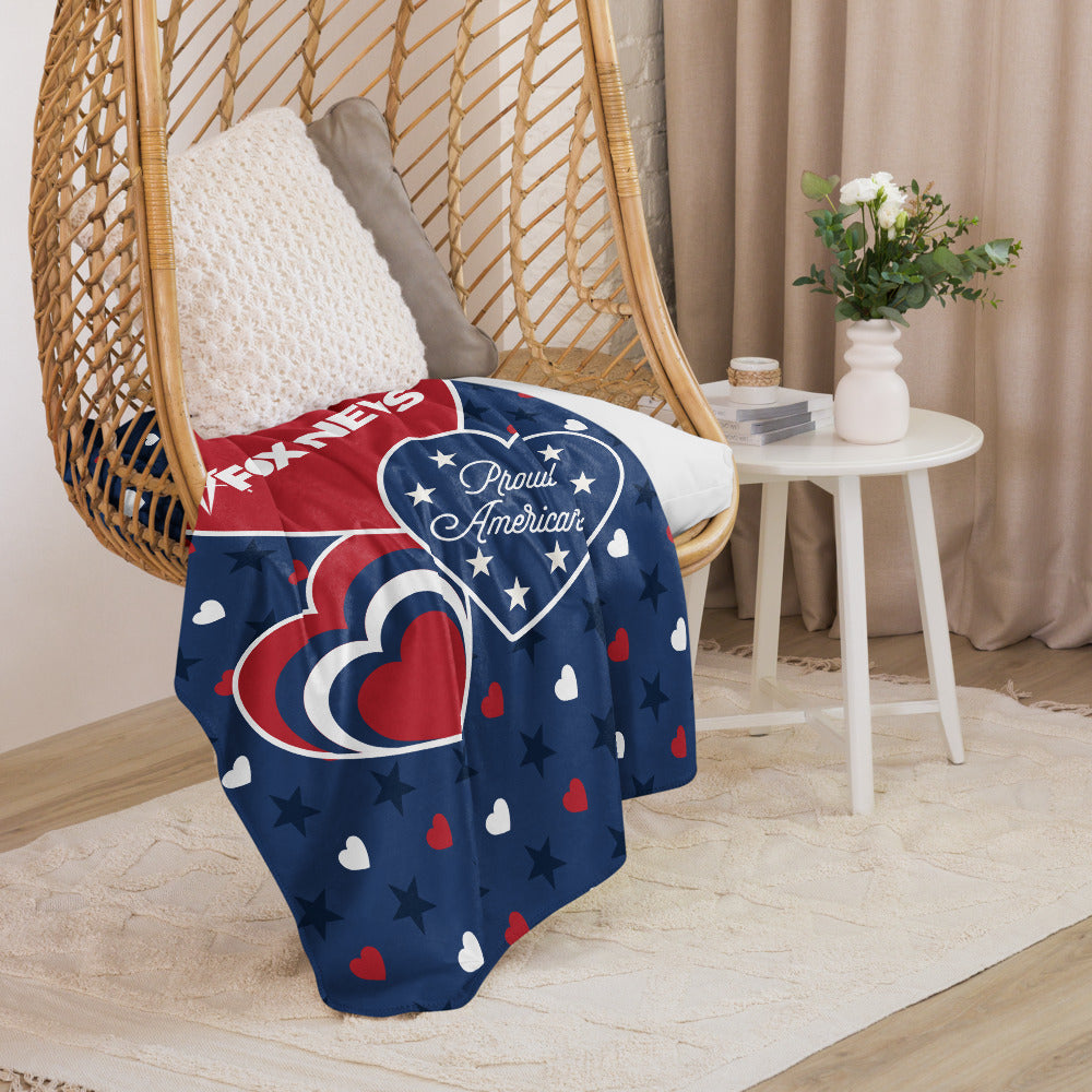 A patriotic Hearts and Stars blanket draped over a sofa in a modern suburban living room.