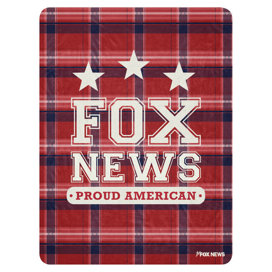 A *FOX News* Proud American Blanket draped over a clean sofa in a modern American living room.