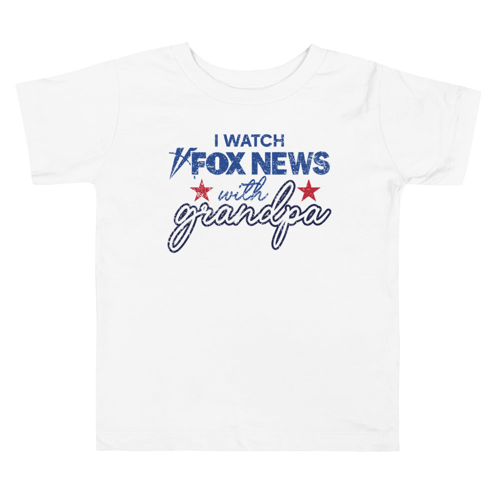 A young child enjoying a family-friendly morning setting while wearing official FOX News merchandise.