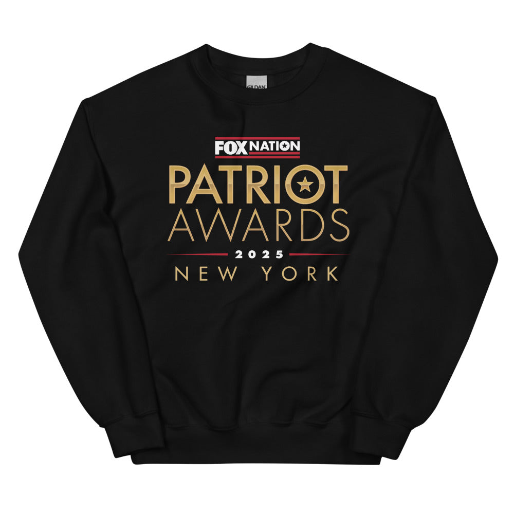 A patriotic American man wearing the FOX Nation Patriot Awards 2025 sweatshirt in a clean, suburban backyard setting.