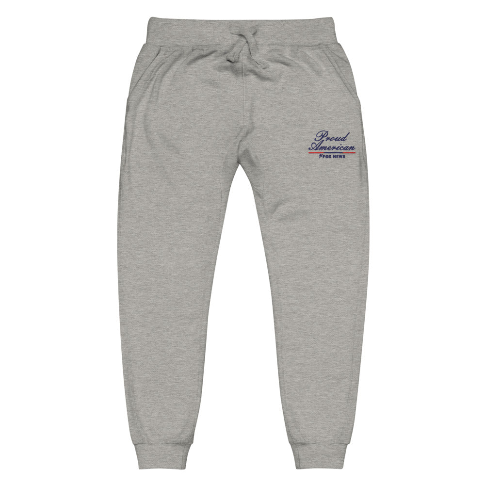 A modern American living room setting featuring a pair of FOX News Proud American sweatpants neatly folded on a comfortable couch.