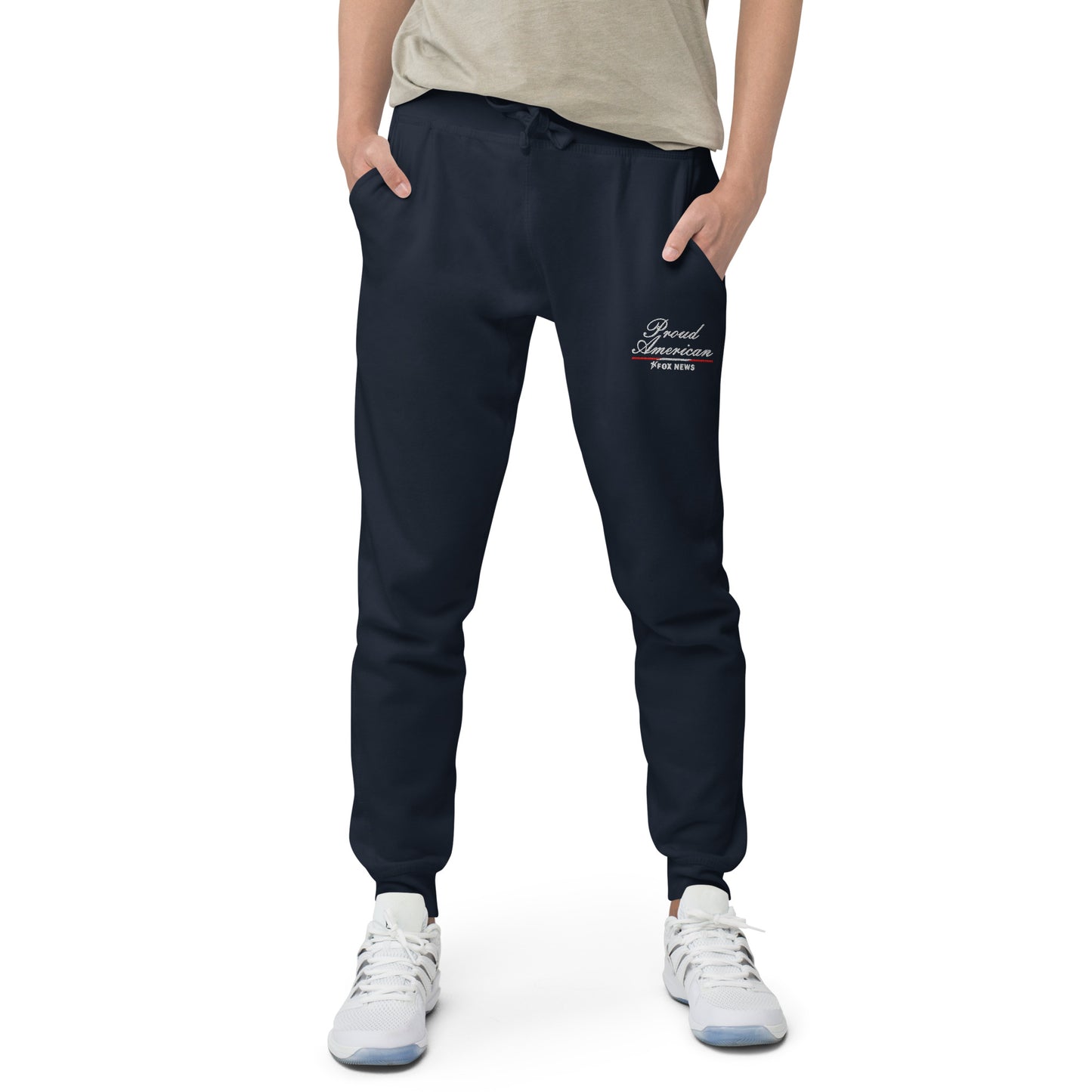 A patriotic-themed flat lay featuring the FOX News sweatpants alongside a cup of coffee and American flag decor.