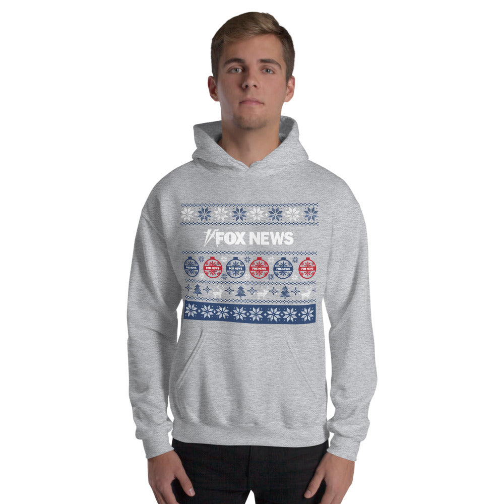 A person wearing the FOX News Holiday Hoodie while relaxing in a modern living room, showcasing the comfortable unisex fit.