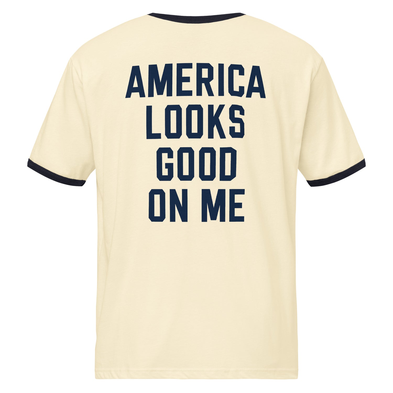 White ringer t-shirt with red contrast trim, featuring the Fox News America Looks Good On Me graphic centered on the chest in a clean suburban living room setting
