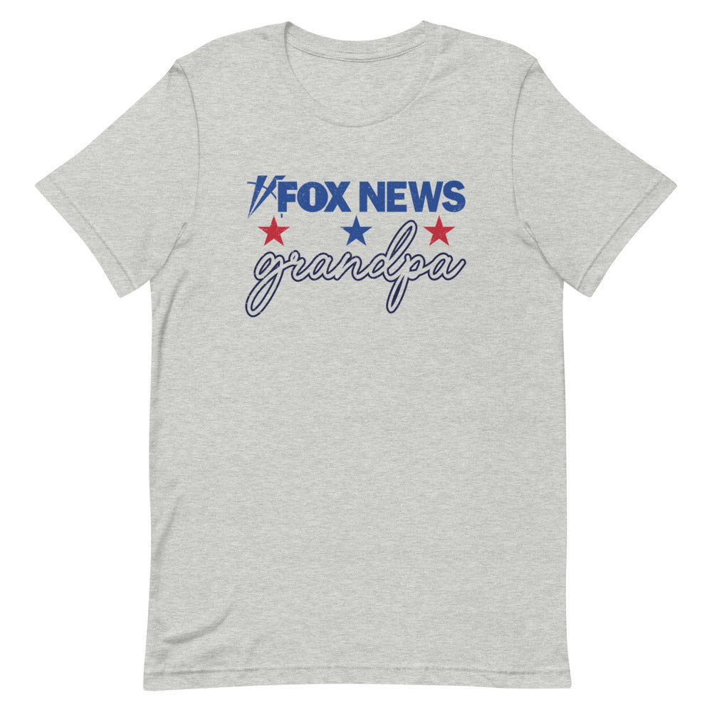 A modern American living room with a grandfather wearing the FOX News Grandpa T-Shirt, relaxing comfortably.
