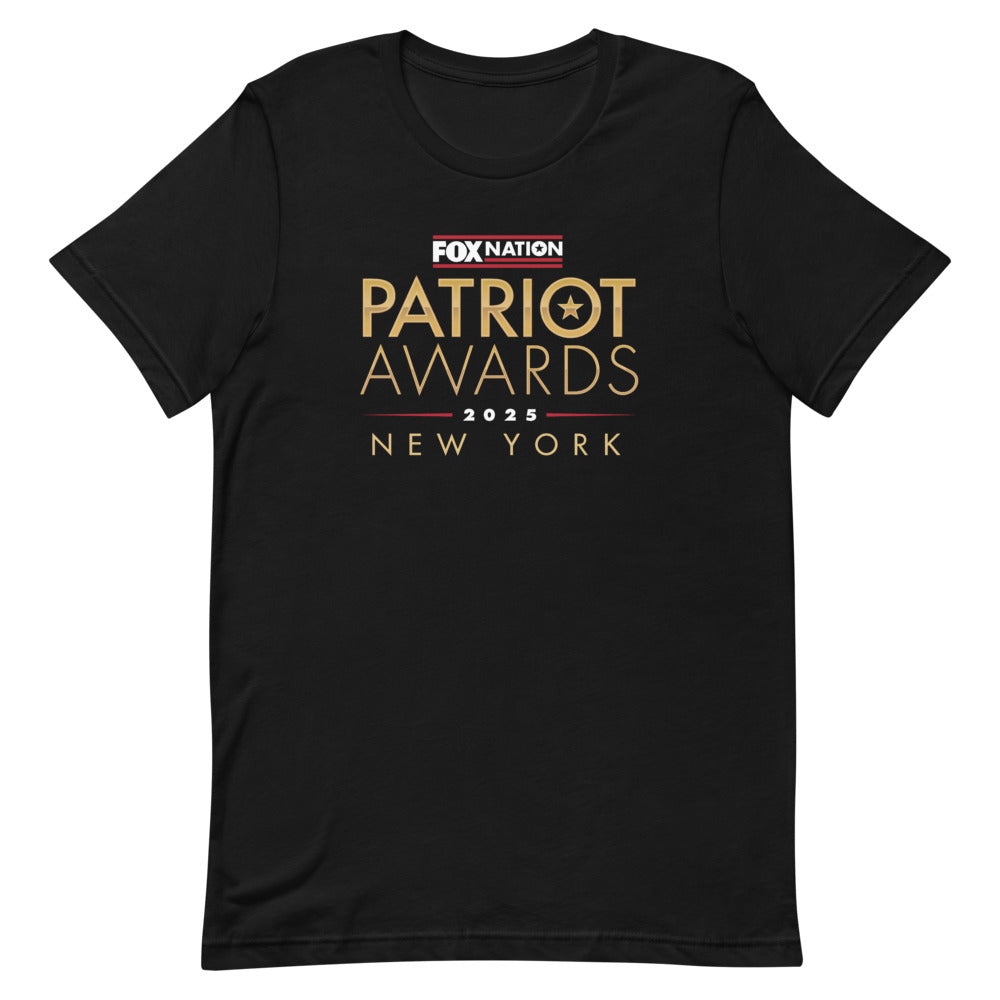 A man wearing the black FOX Nation Patriot Awards 2025 T-shirt in a clean American backyard setting.