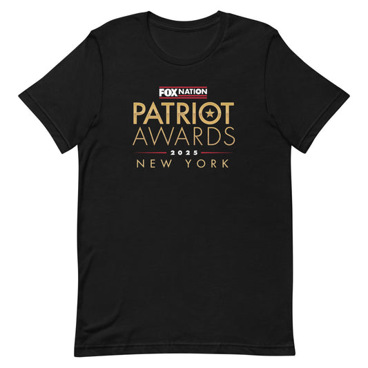 A man wearing the black FOX Nation Patriot Awards 2025 T-shirt in a clean American backyard setting.