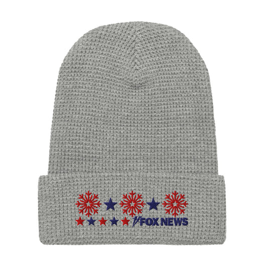 A person wearing the FOX News Holiday Snowflakes Beanie in a cozy American home setting.-3