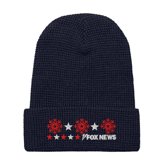A person wearing the FOX News Holiday Snowflakes Beanie in a cozy American home setting.-6