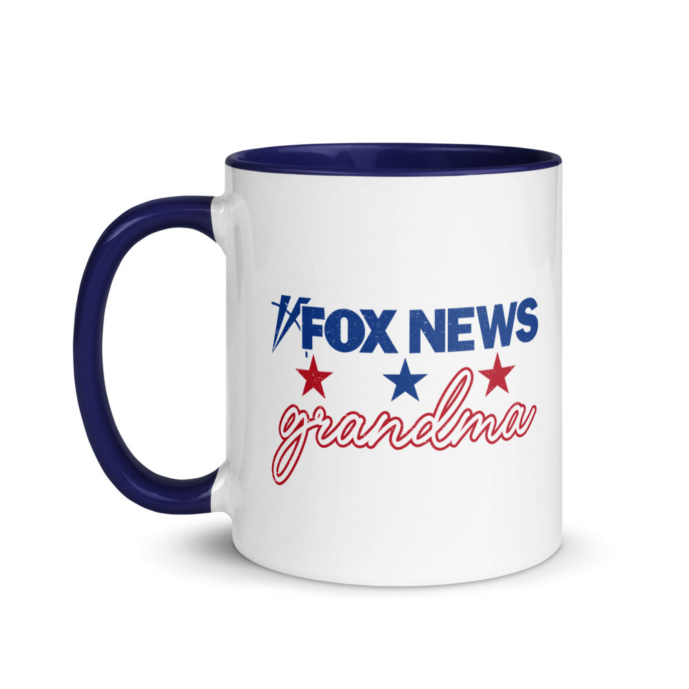 A FOX News Grandma Two-tone Mug with a red interior and handle sitting on a clean kitchen counter.