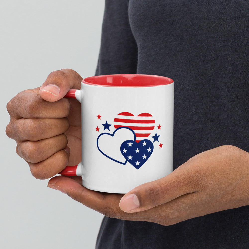 A smiling Caucasian man in a suburban home setting holding the Gutfeld! Hearts Two-tone Mug while relaxing in his living room.