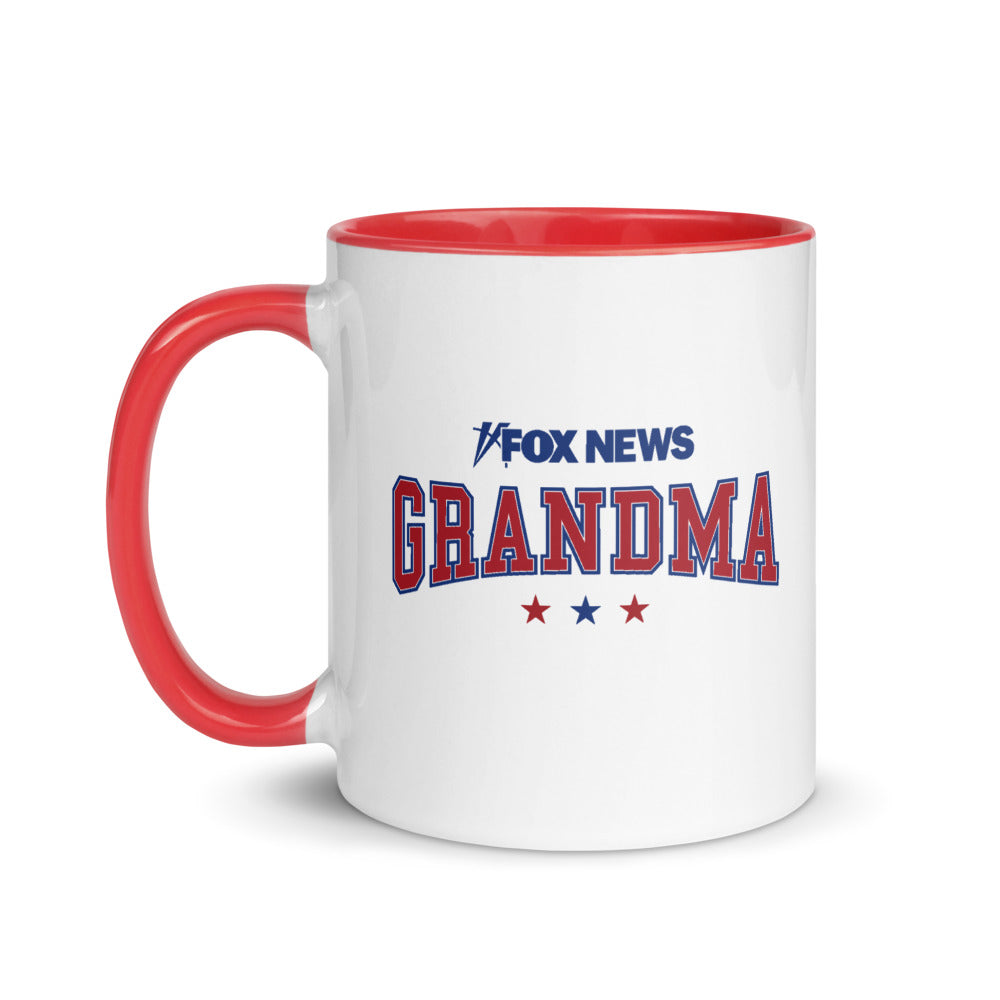 A white ceramic FOX News Grandma mug with a vibrant red handle and interior, shown on a clean kitchen counter in a modern American home.