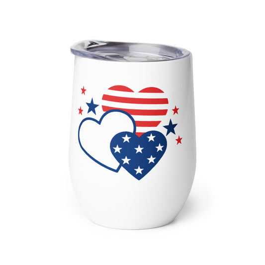 The 12oz FOX News insulated wine tumbler shown on a wooden outdoor table in a patriotic backyard setting.