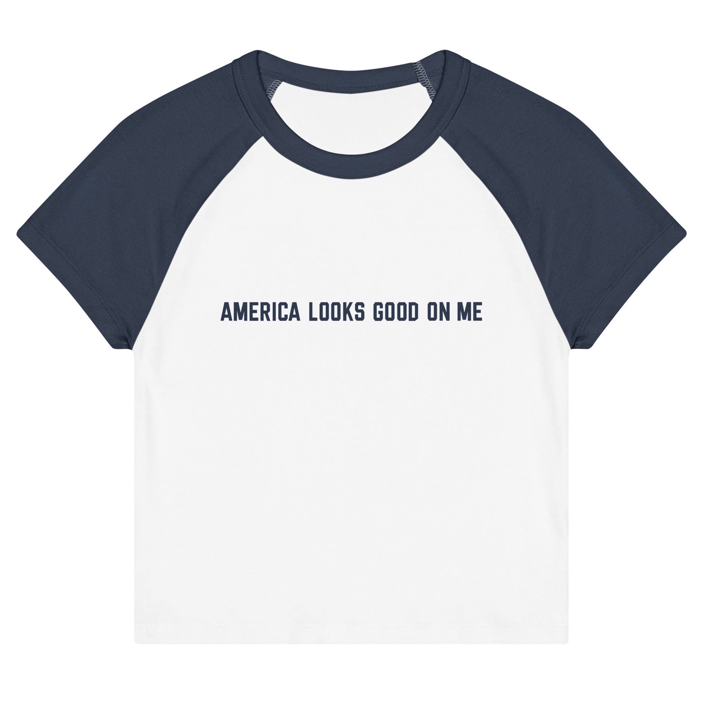 Women's fitted raglan baby tee featuring the red, white, and blue FOX News logo and America Looks Good On Me text across the chest, displayed against a clean American living room setting.