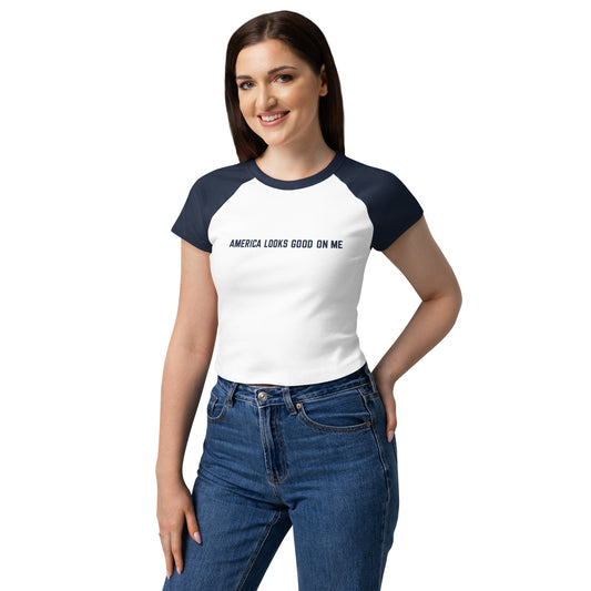 Close-up view of the FOX News America Looks Good On Me graphic printed on the soft cotton-polyester fabric of the women's raglan baby tee.