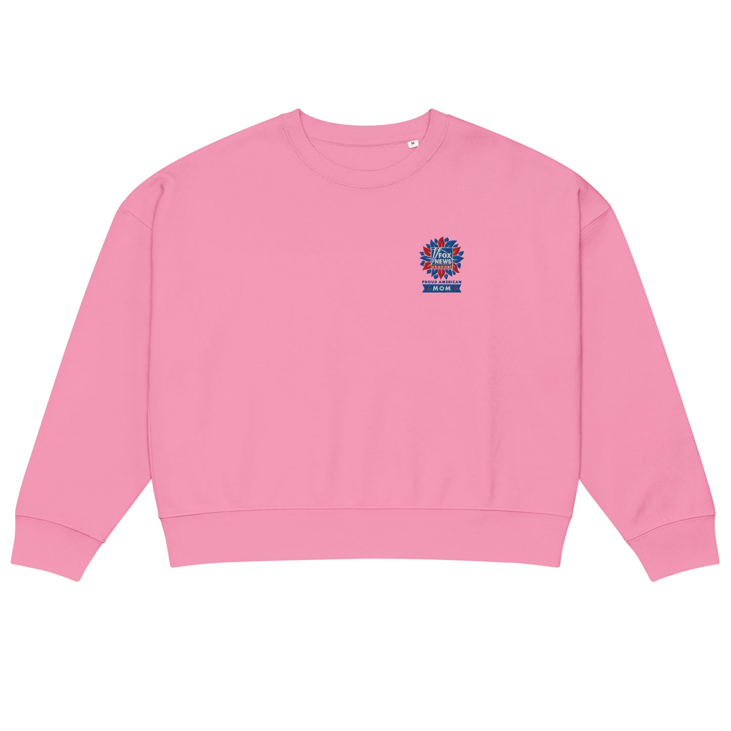 A woman standing in a bright, suburban backyard setting wearing the French Navy FOX News Proud American Mom embroidered sweatshirt.